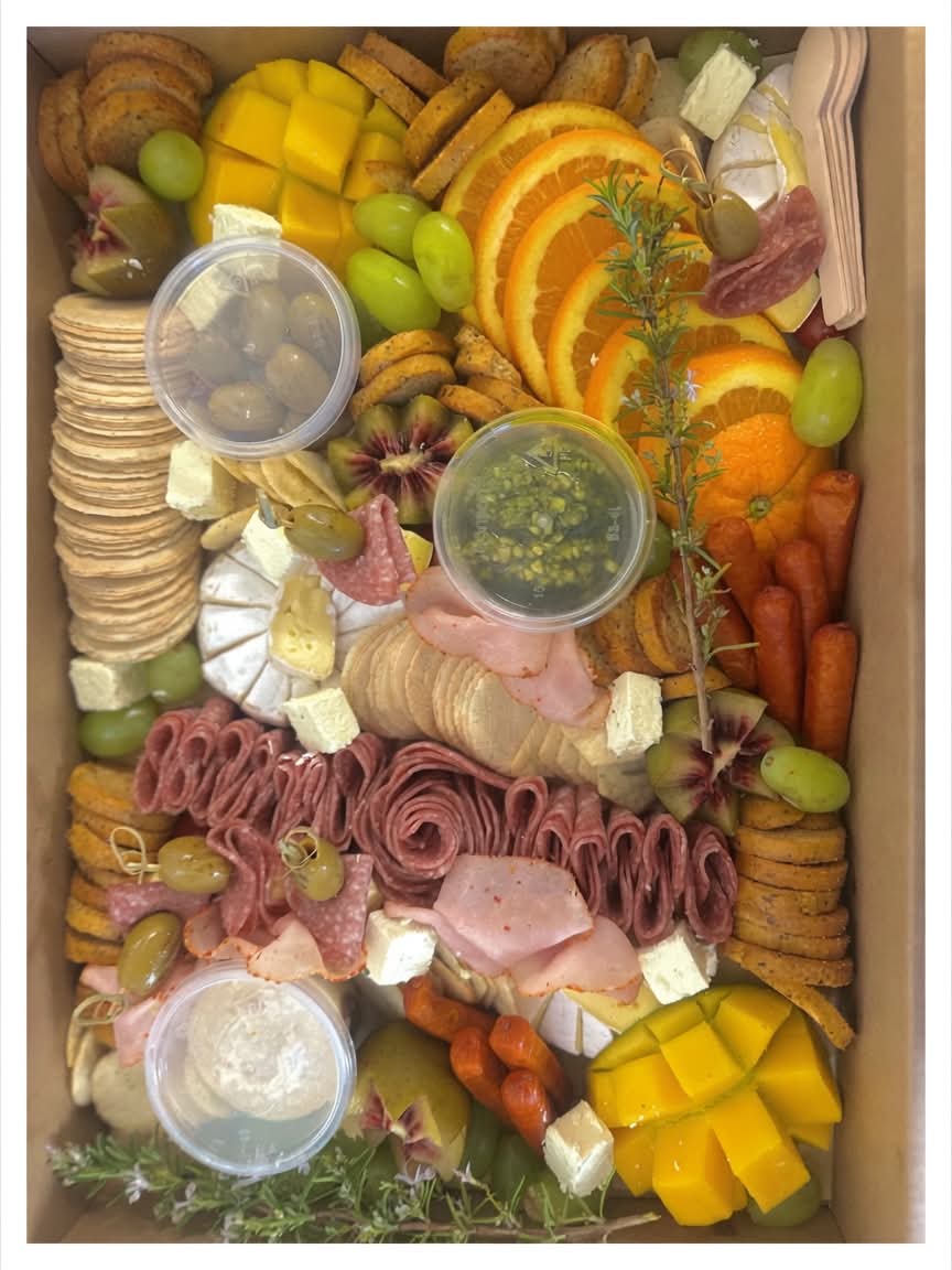 Charcuterie platter with cured meats, crackers, olives and dip